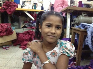 Meem, 9, at work in a Bangladesh garment factory